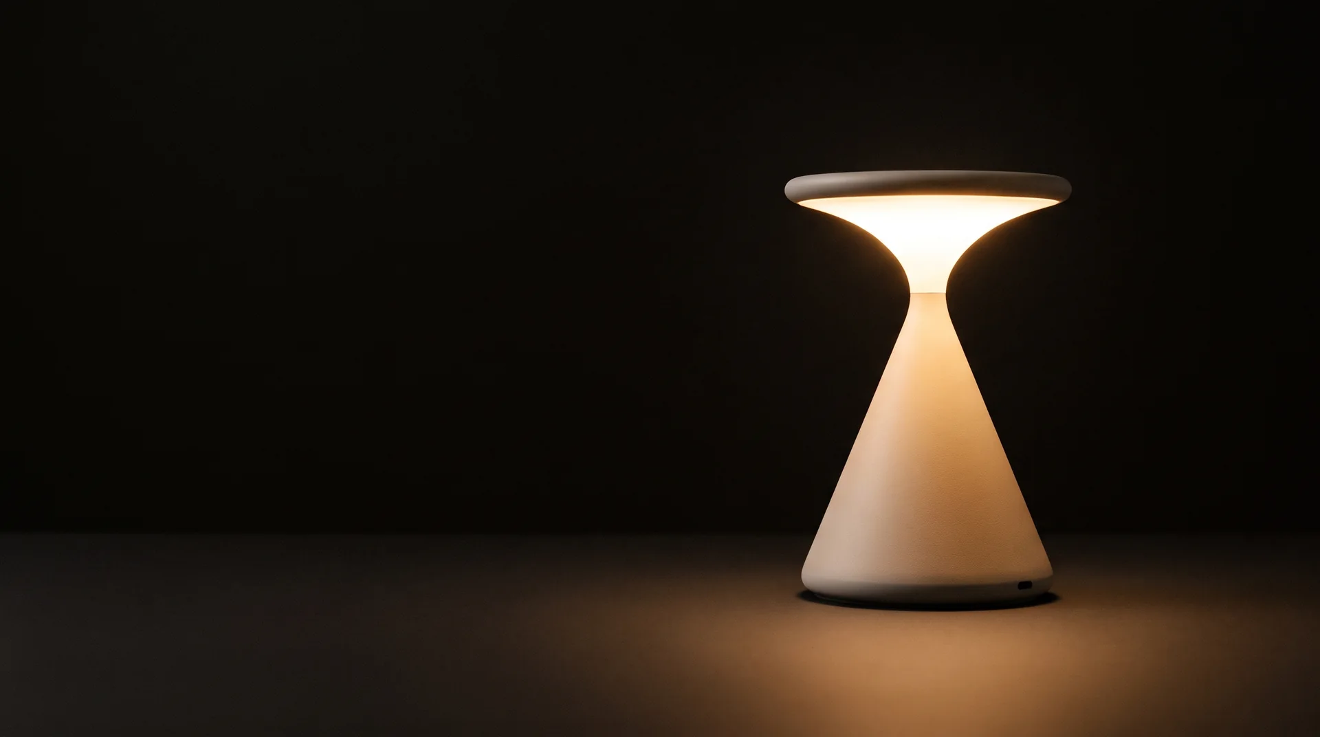 The GRAU Salt lamp, lit, in a dark studio