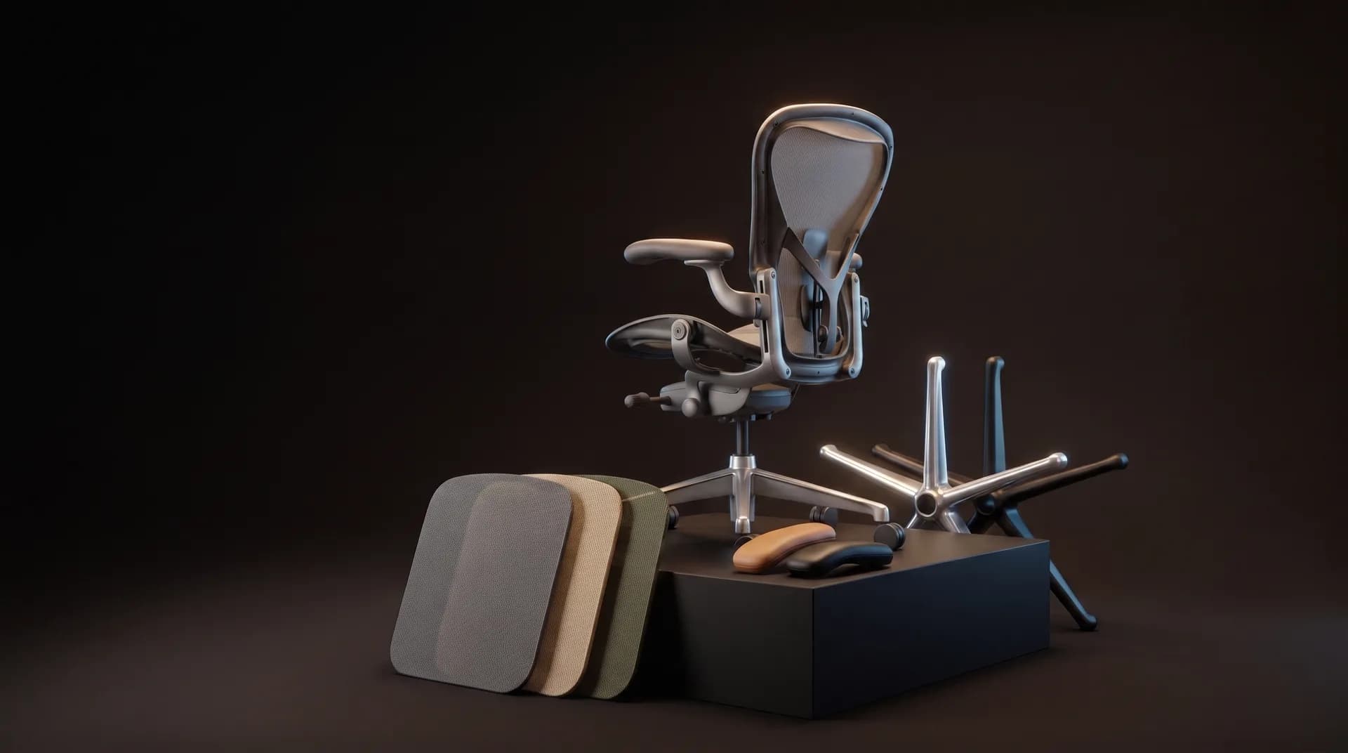 An office chair beside three fabric swatches, in a dark studio